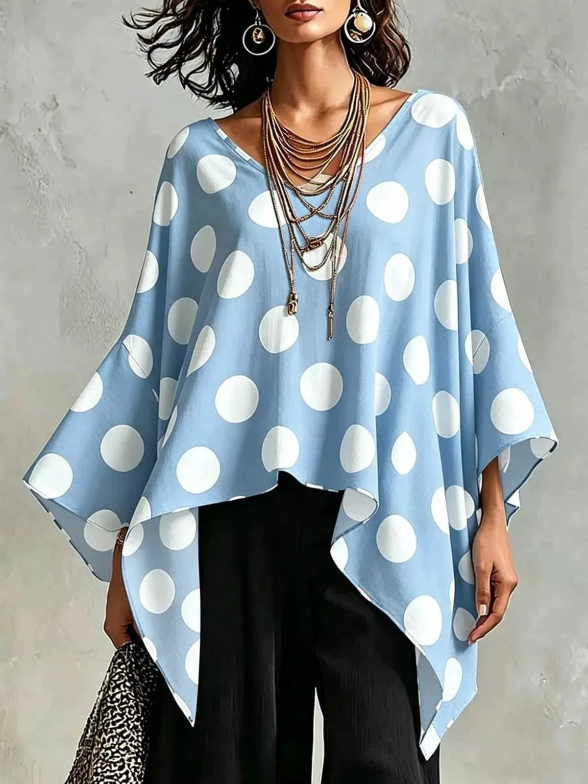 Polka dot asymmetrical hem blouse front view on model