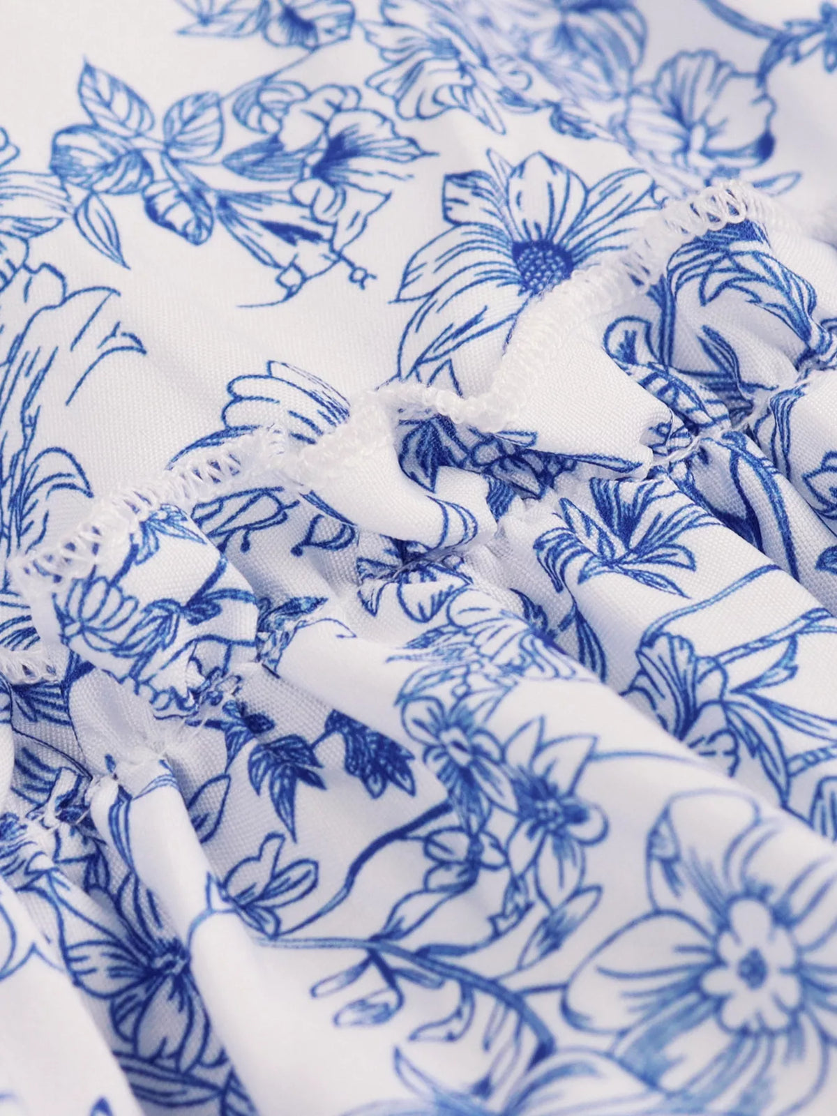 Blue floral halter neck ruffle hem summer dress, close up detail