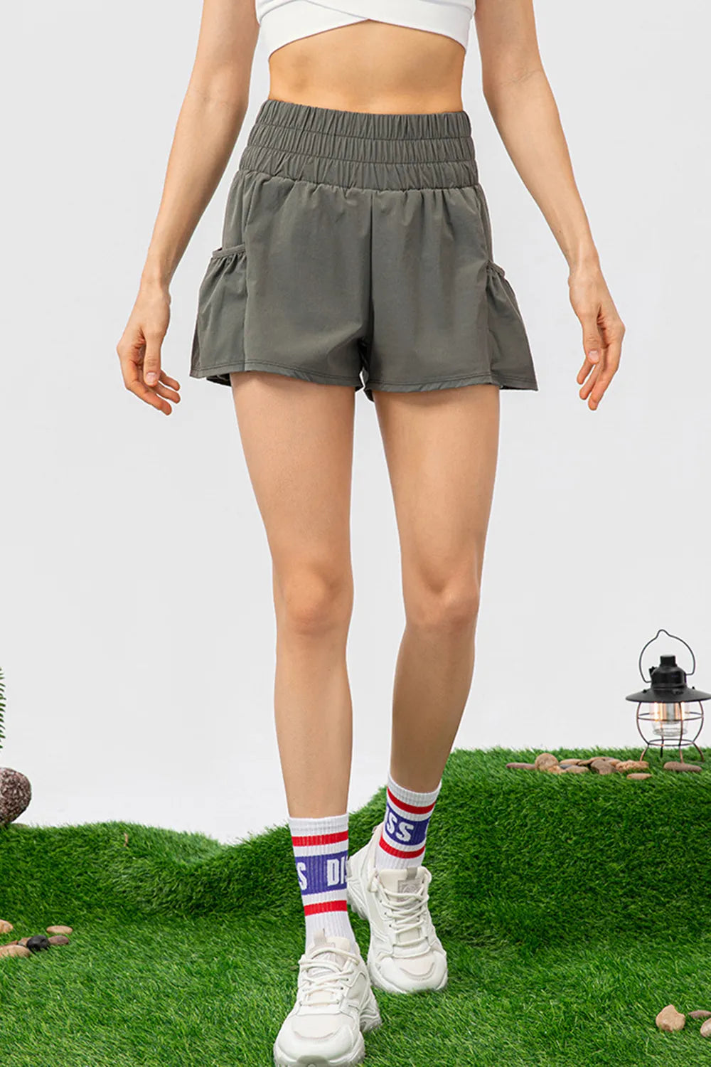 Elastic waist pocketed active shorts standing view
