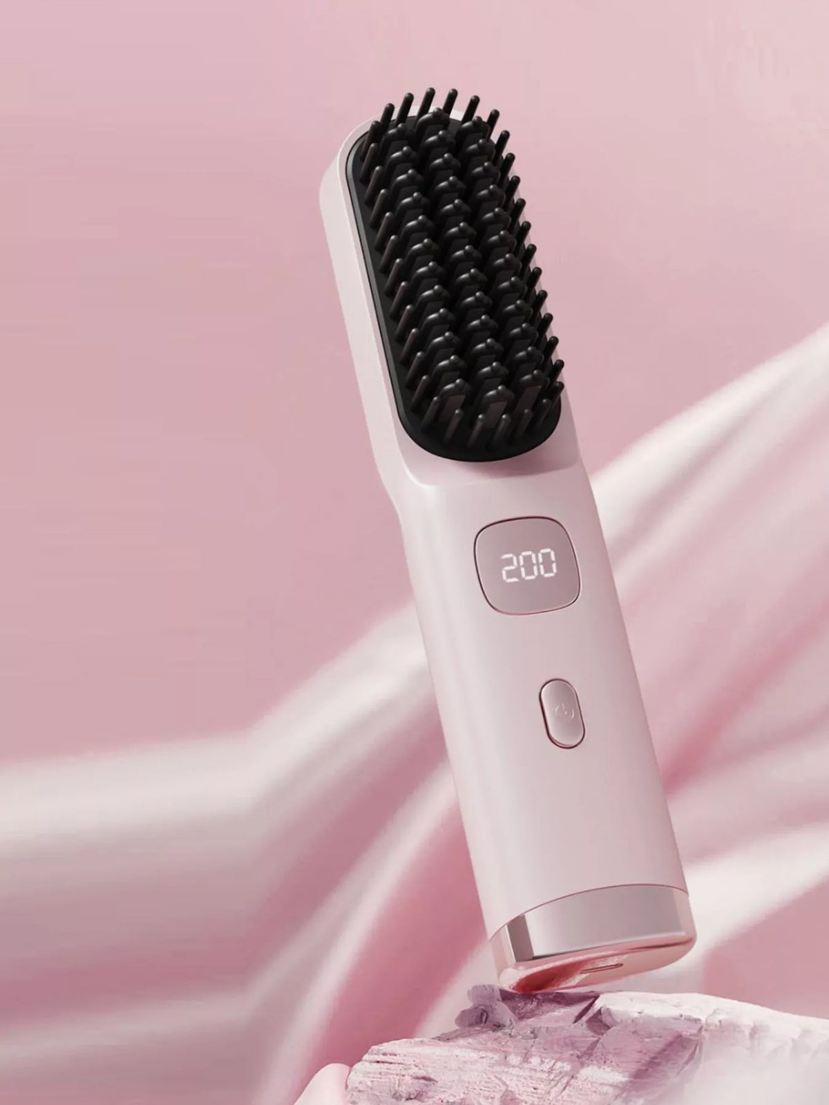 Heated straightening comb in blush pink