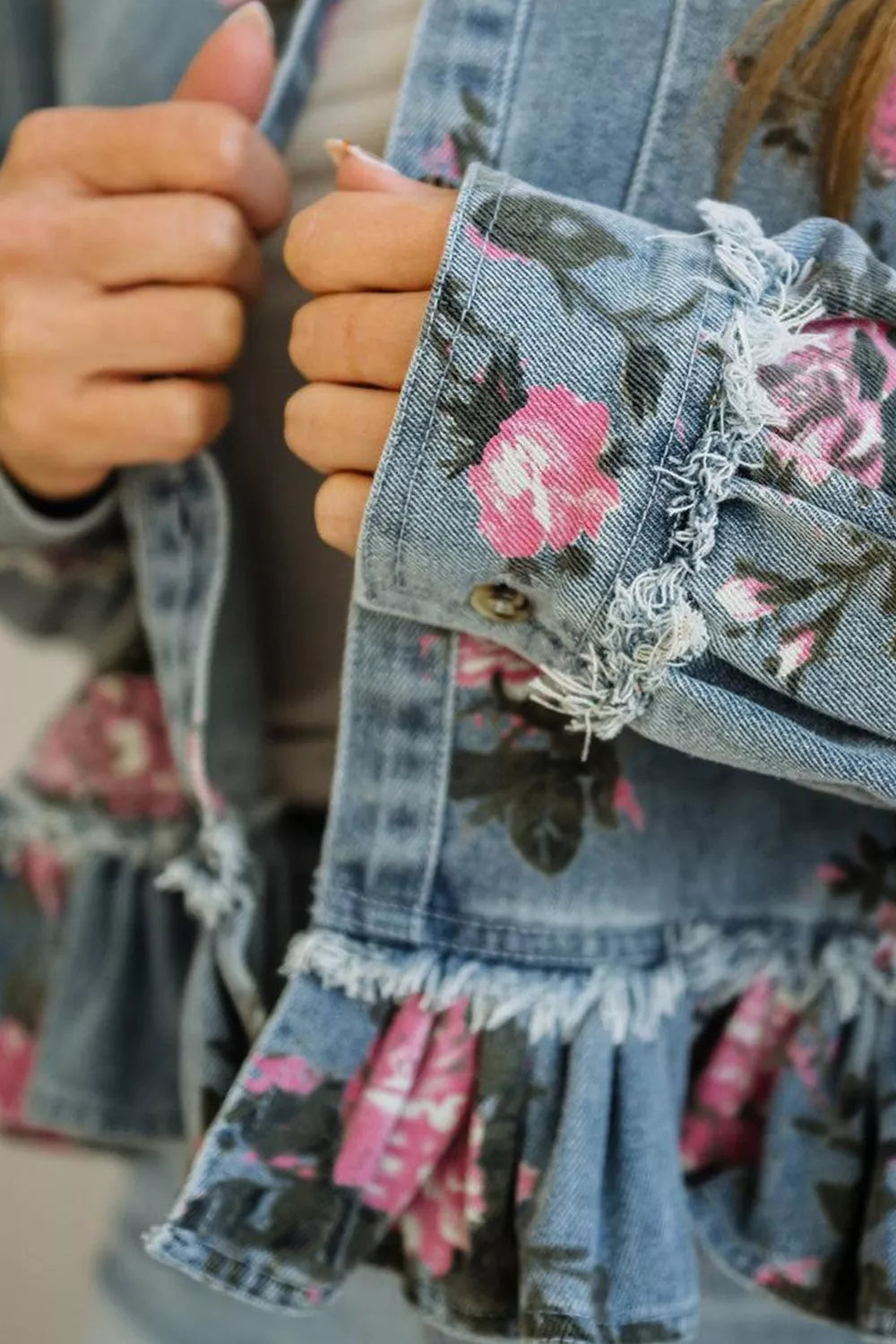 Detail of the frayed cuff on the denim jacket sleeve