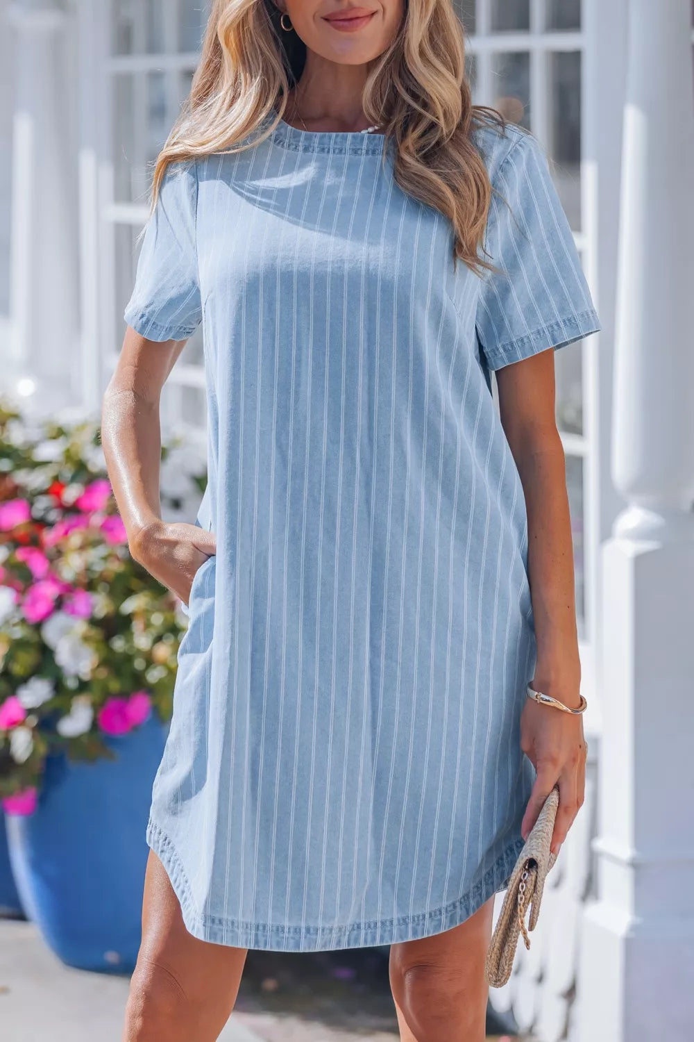 Light blue striped button back denim mini dress, side view