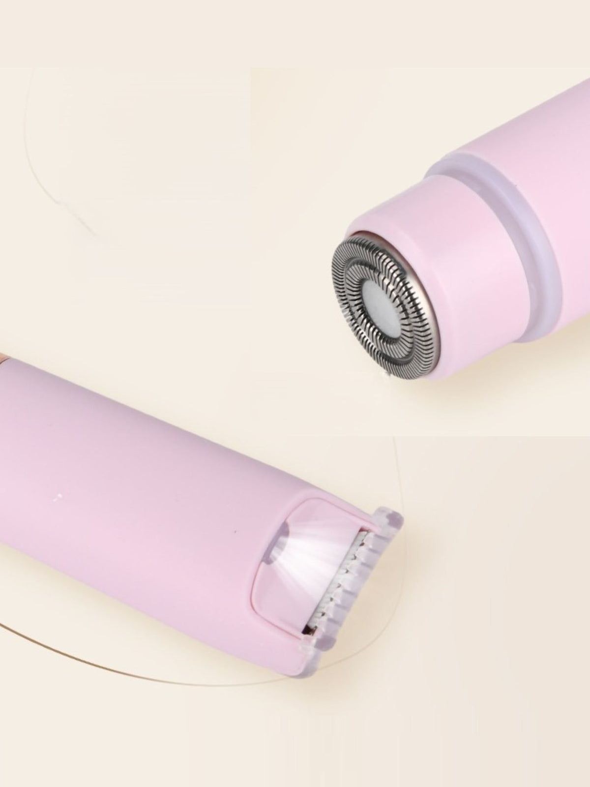 Woman using pink epilator on smooth skin