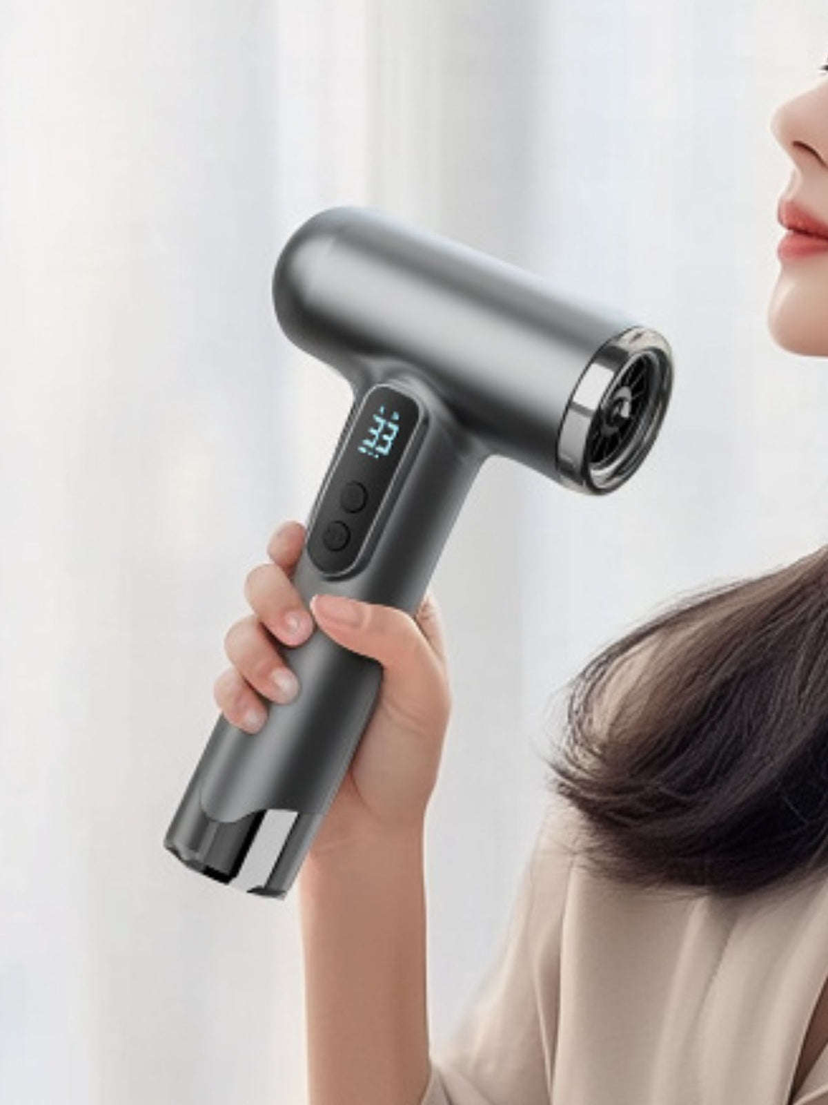 Portable hair dryer held in hand