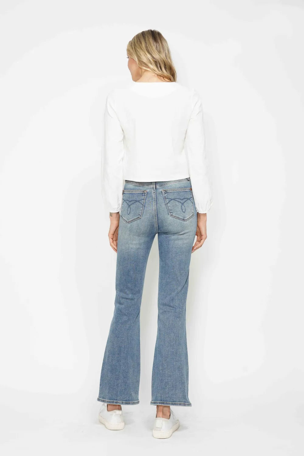 Bootcut leg opening and hem detail on the denim
