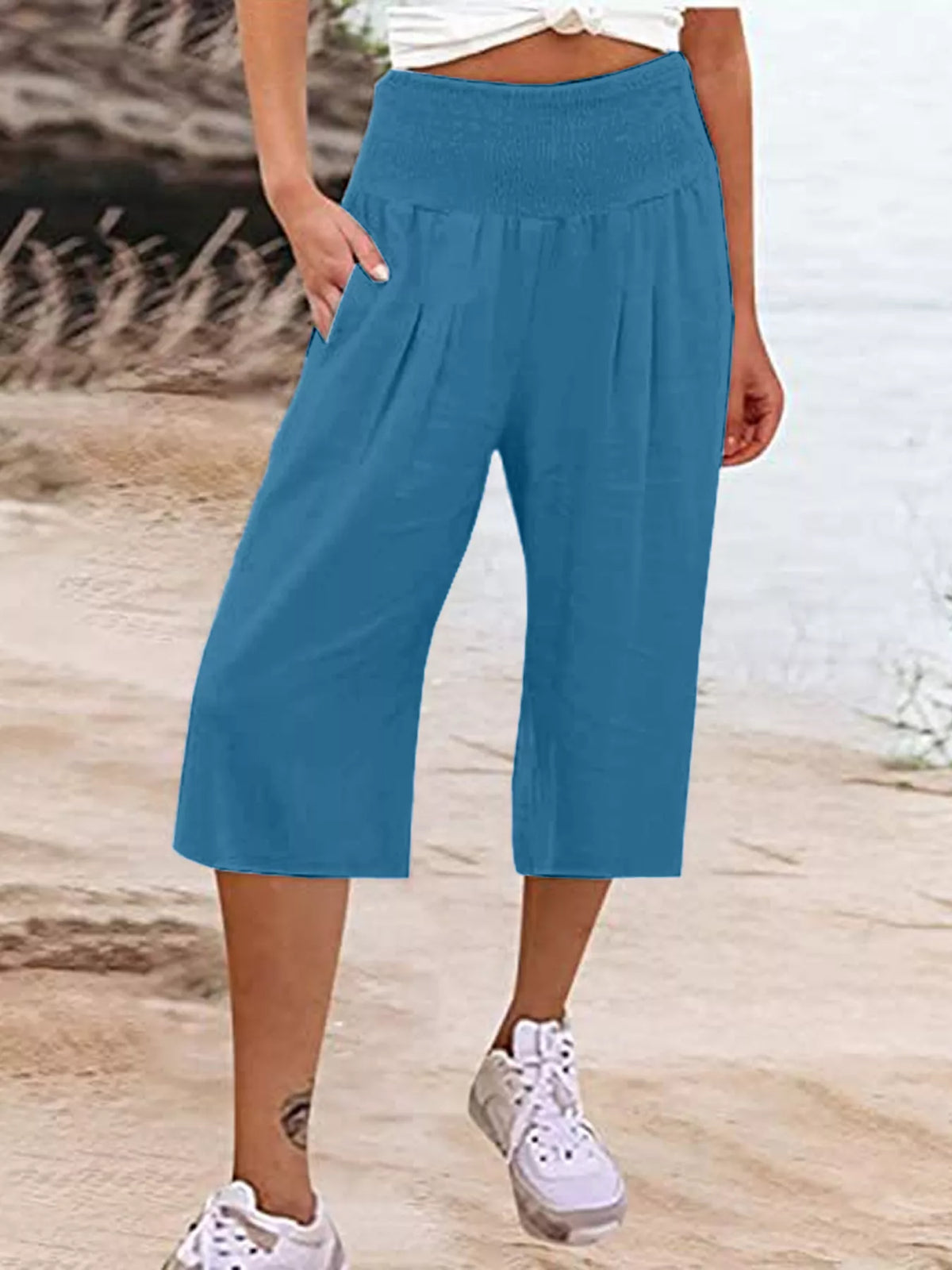 Smocked capri pants shown in a peacock blue colorway