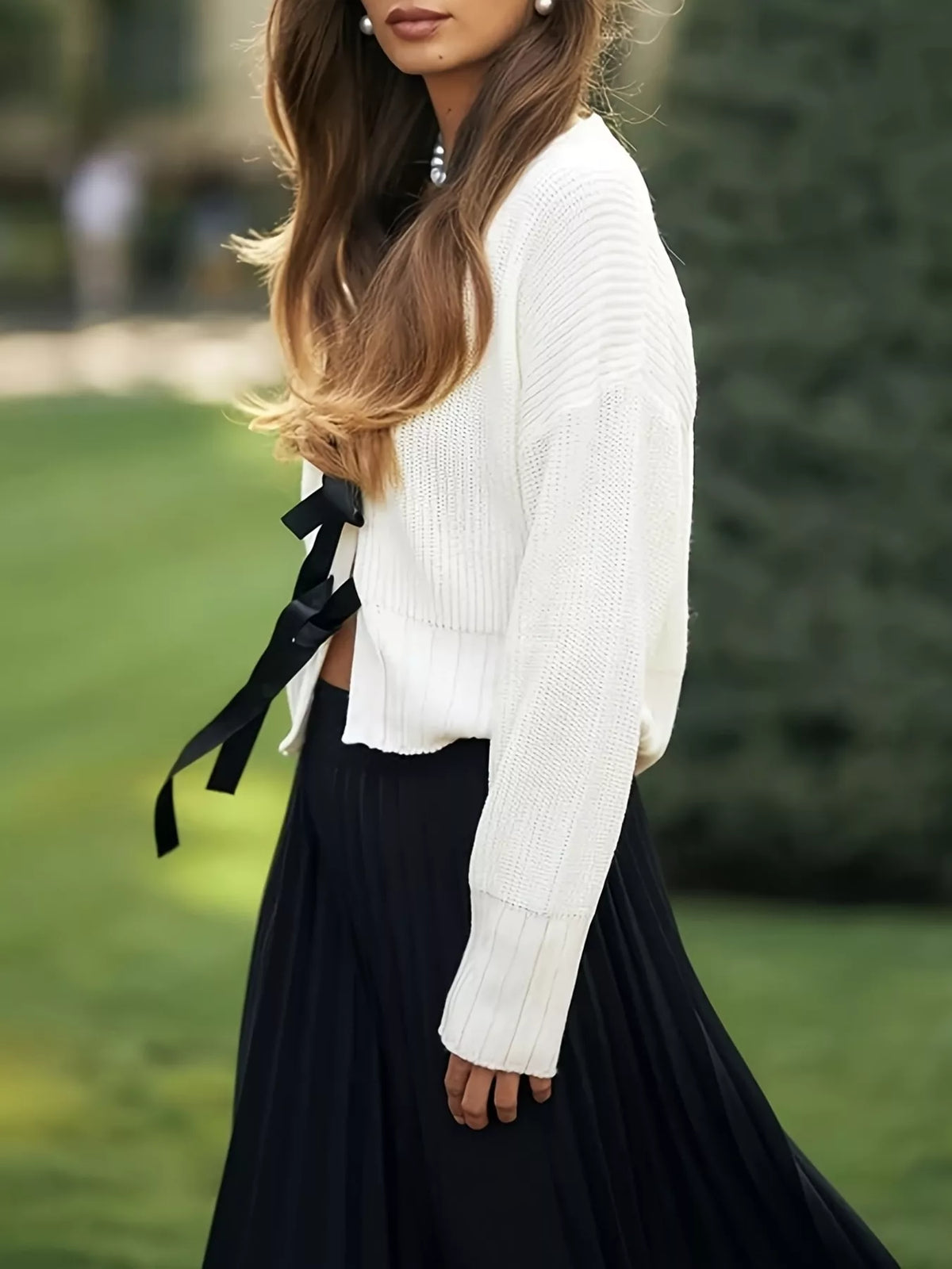 White knit cardigan bow tie closeup