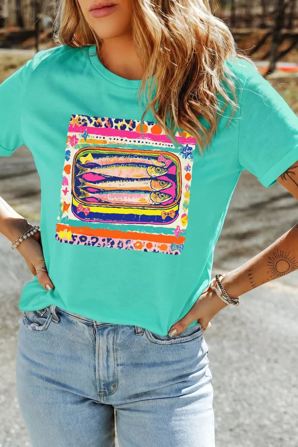 Turquoise graphic tee with a sardine can print