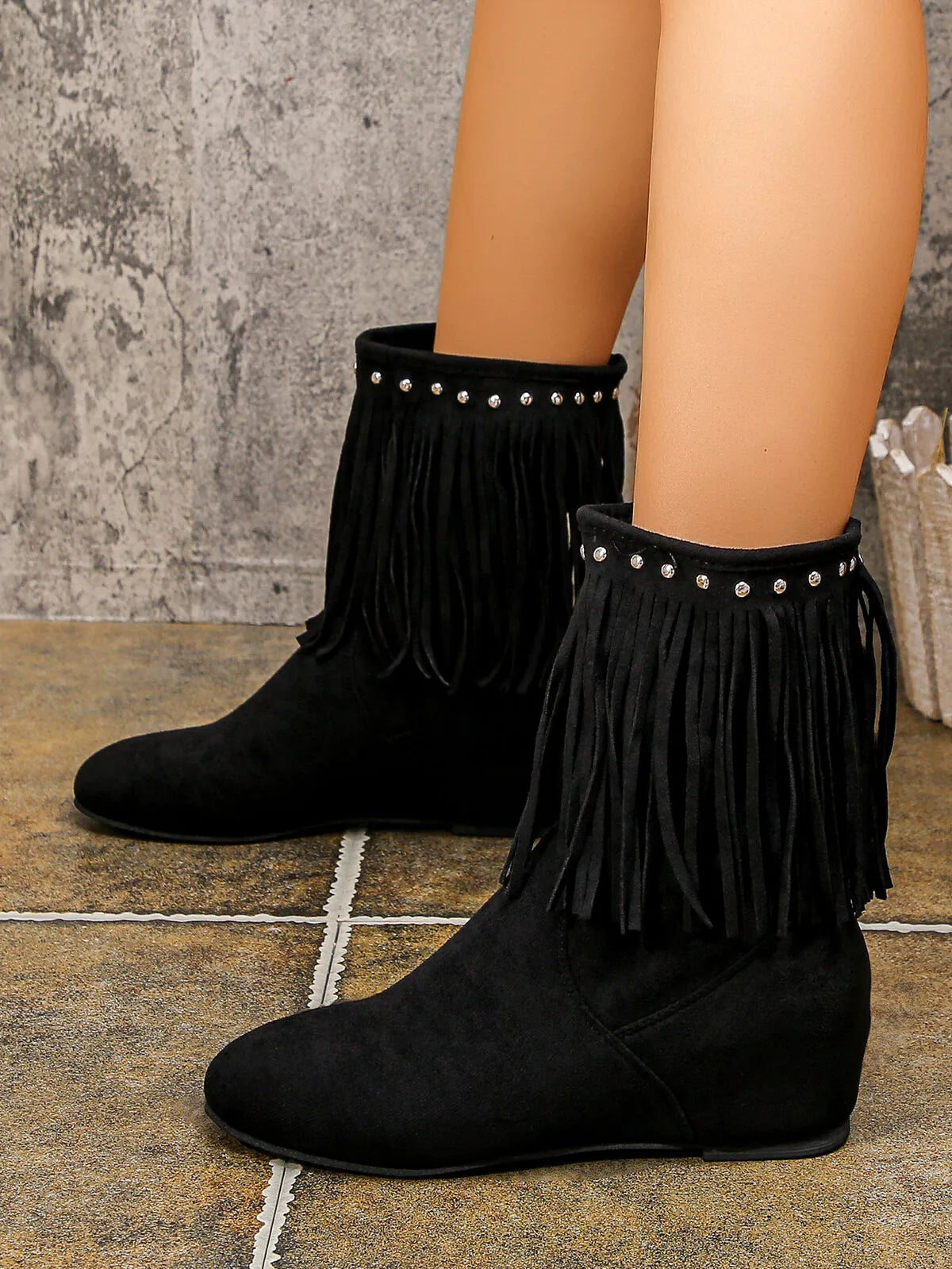 Studded fringe boots pair standing together