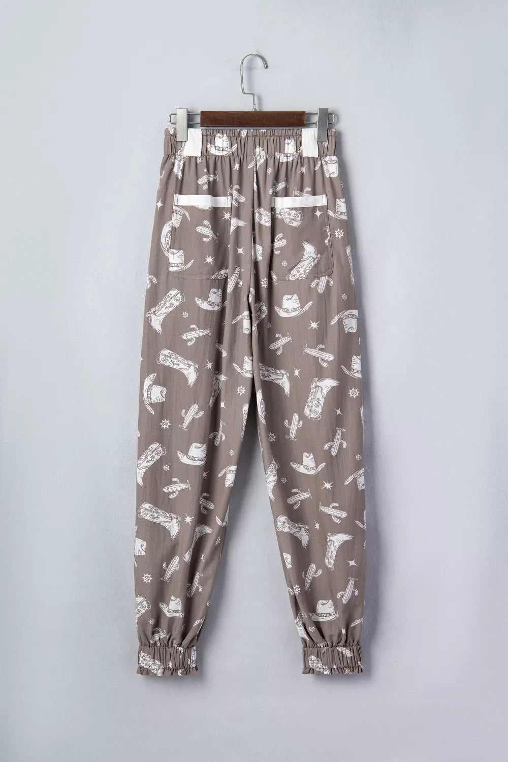 Mocha western cactus print drawstring jogger pants, close up fabric detail