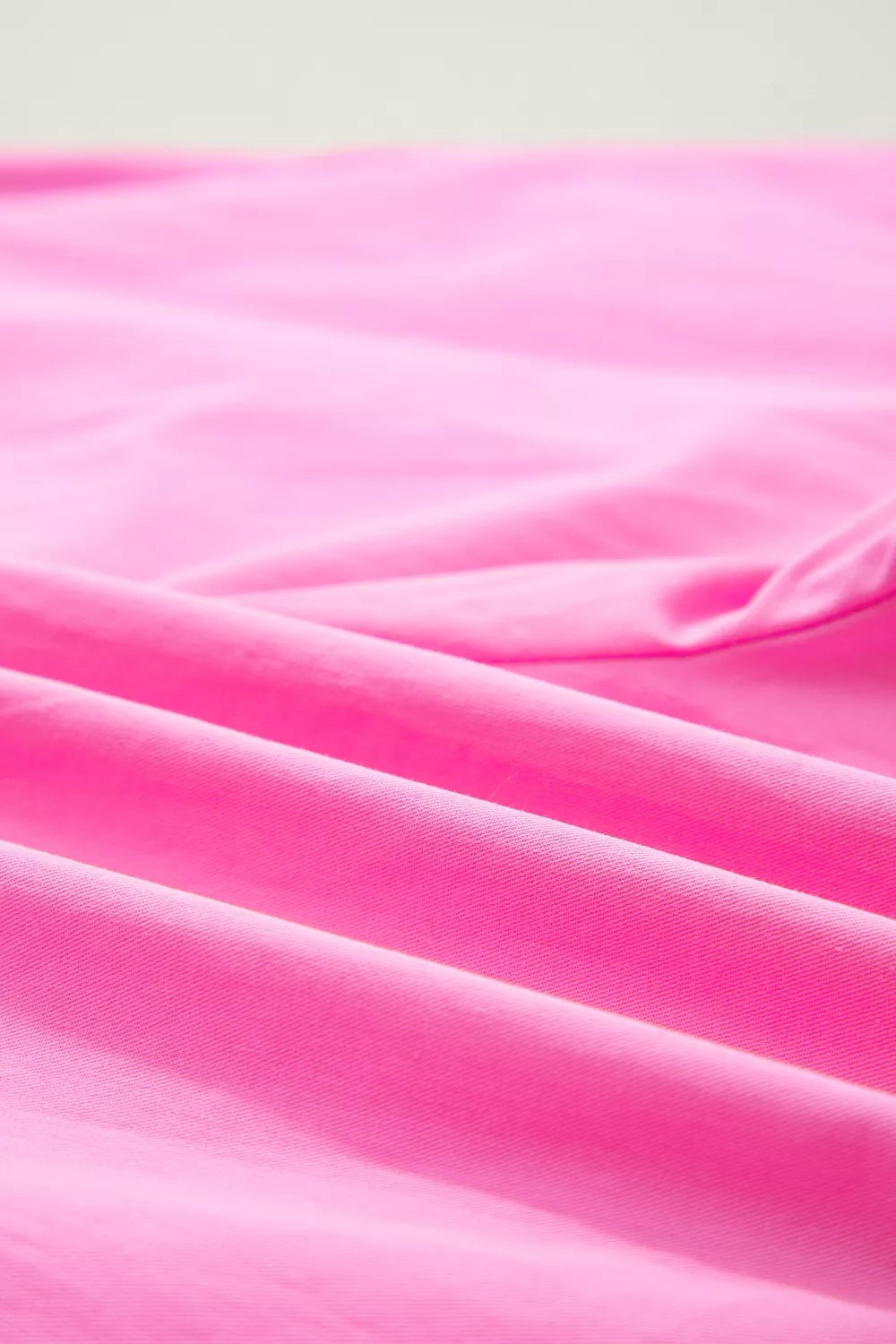 Fuchsia pink pleated wide leg shorts with leopard sash belt side view