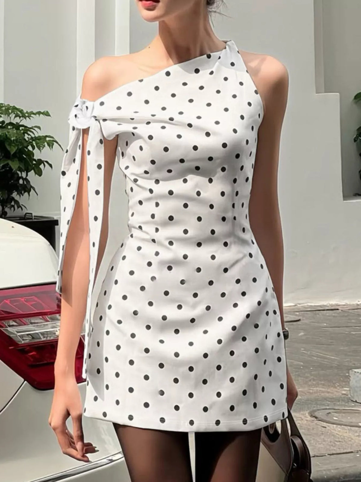 Back view of the white polka dot sleeveless mini dress