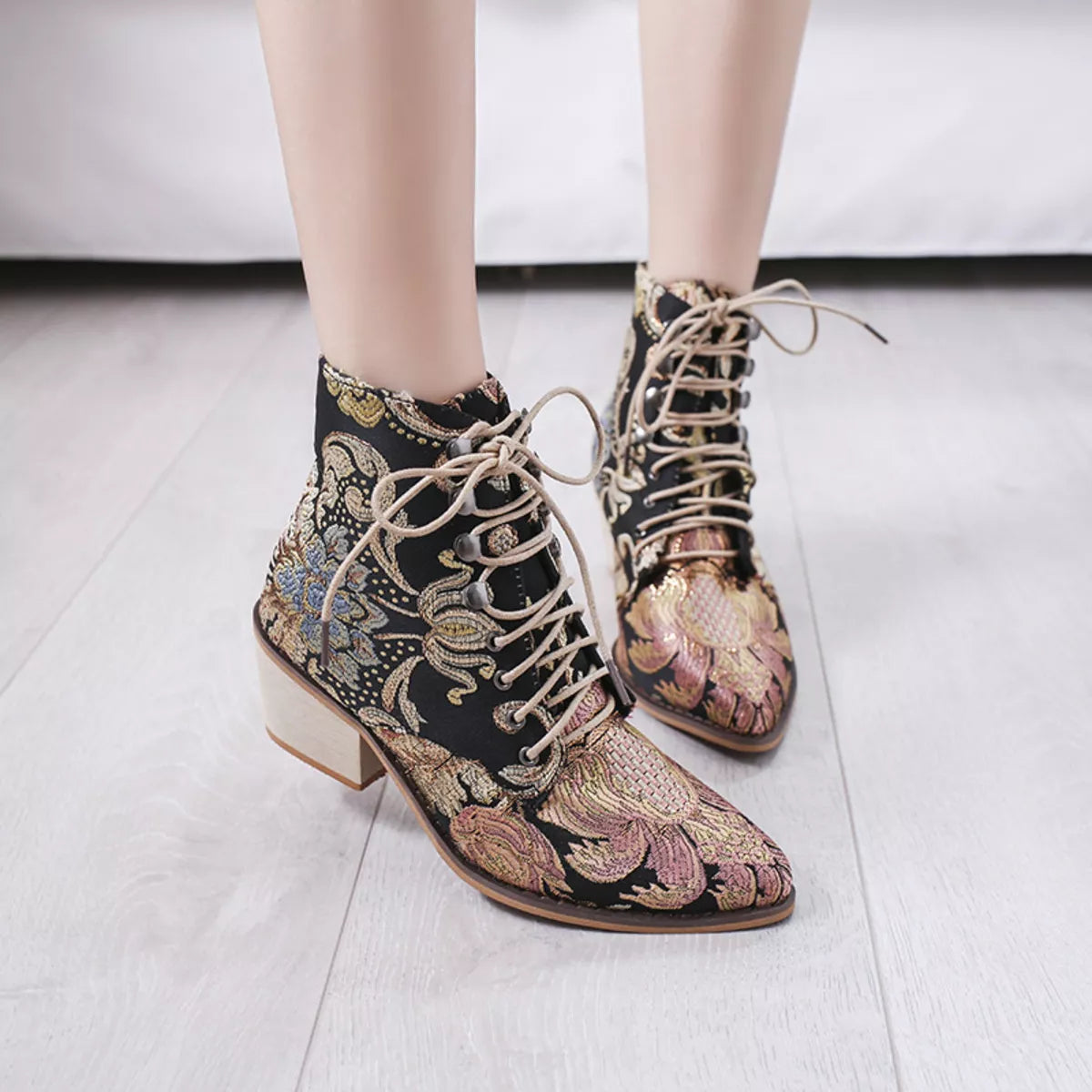 Gold embroidered floral lace up ankle boots close up of the toe