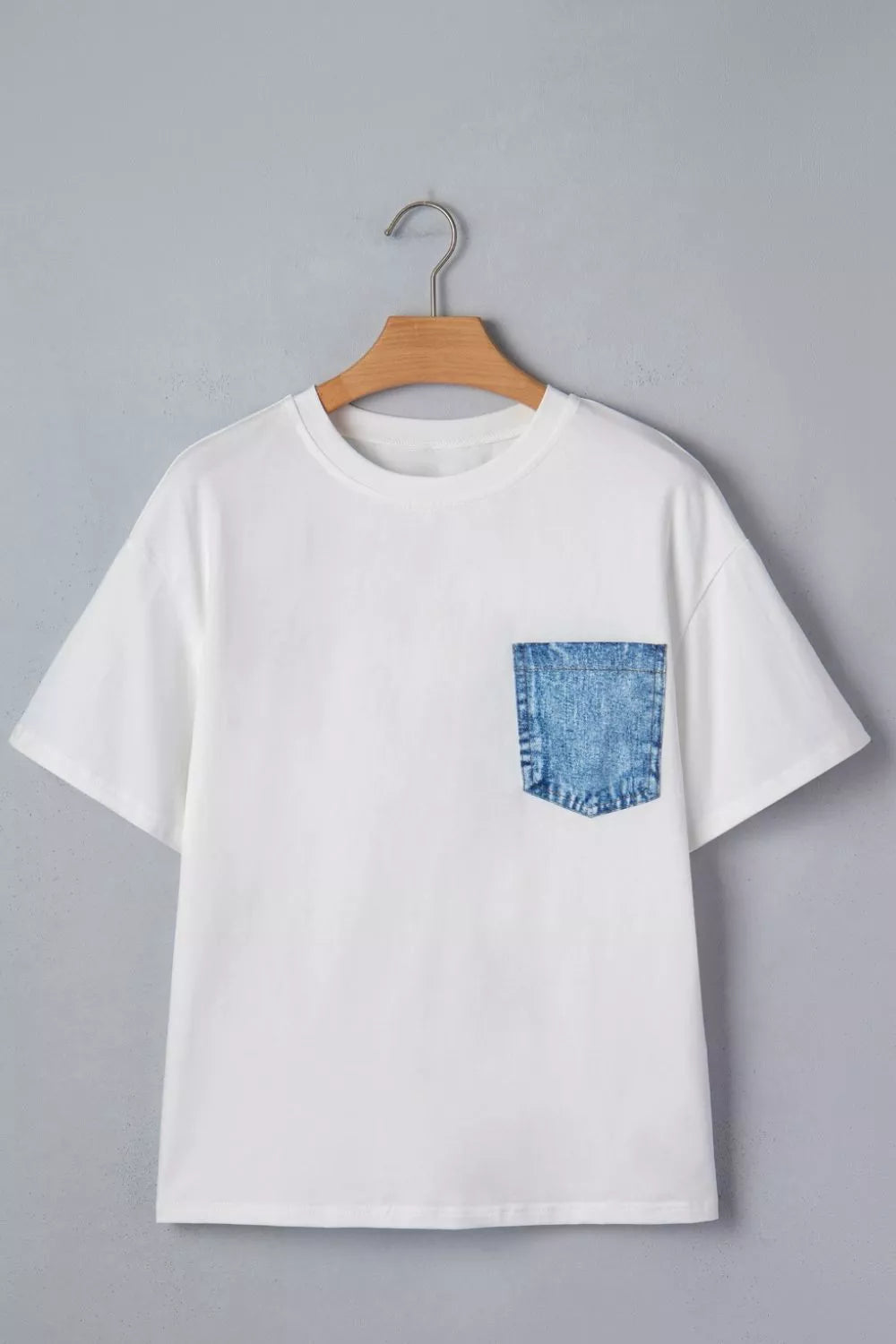 White color block short sleeve top with chest pocket close up detail