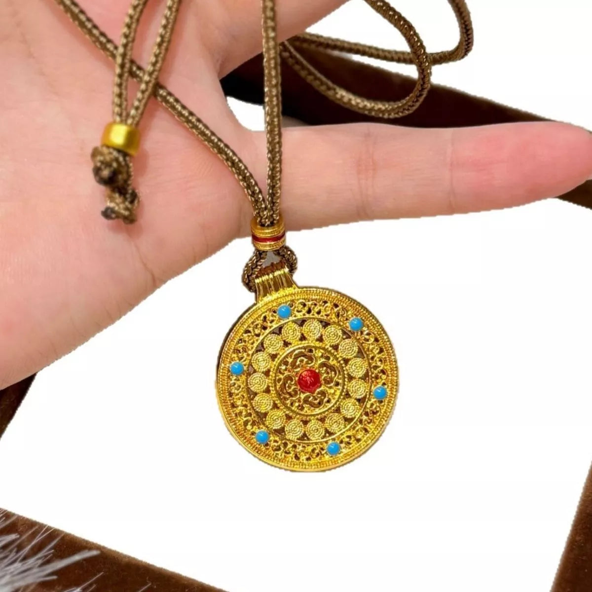 Gold pendant necklace flat lay detail