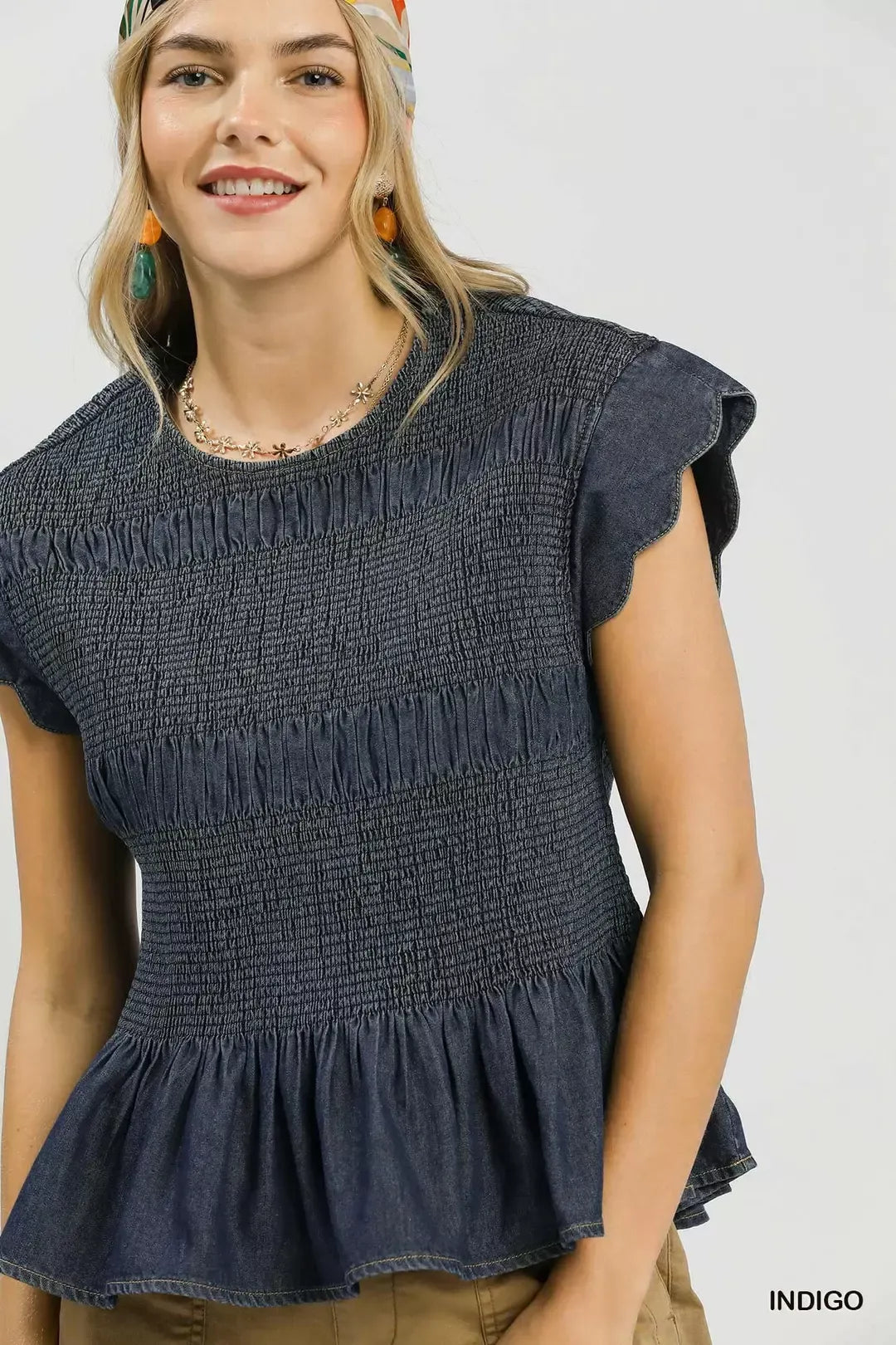 Indigo smocked bodice peplum top detail