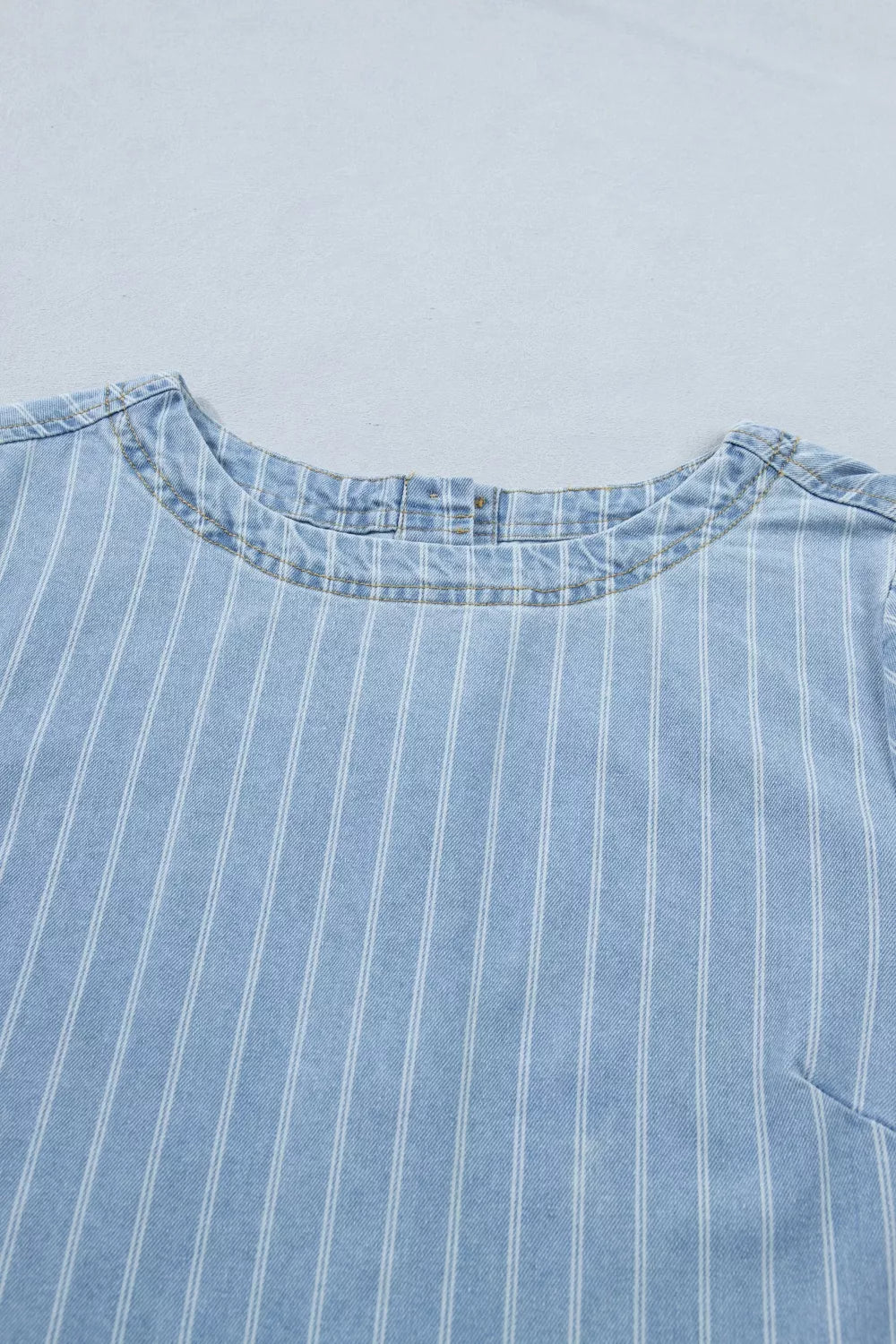 Light blue striped button back denim mini dress, on model view