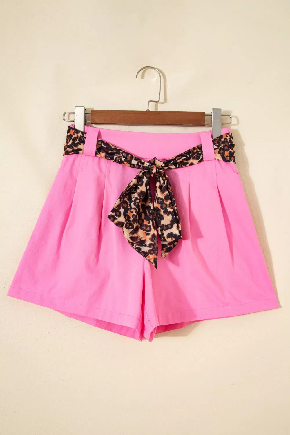 Fuchsia pink pleated wide leg shorts with leopard sash belt detail view