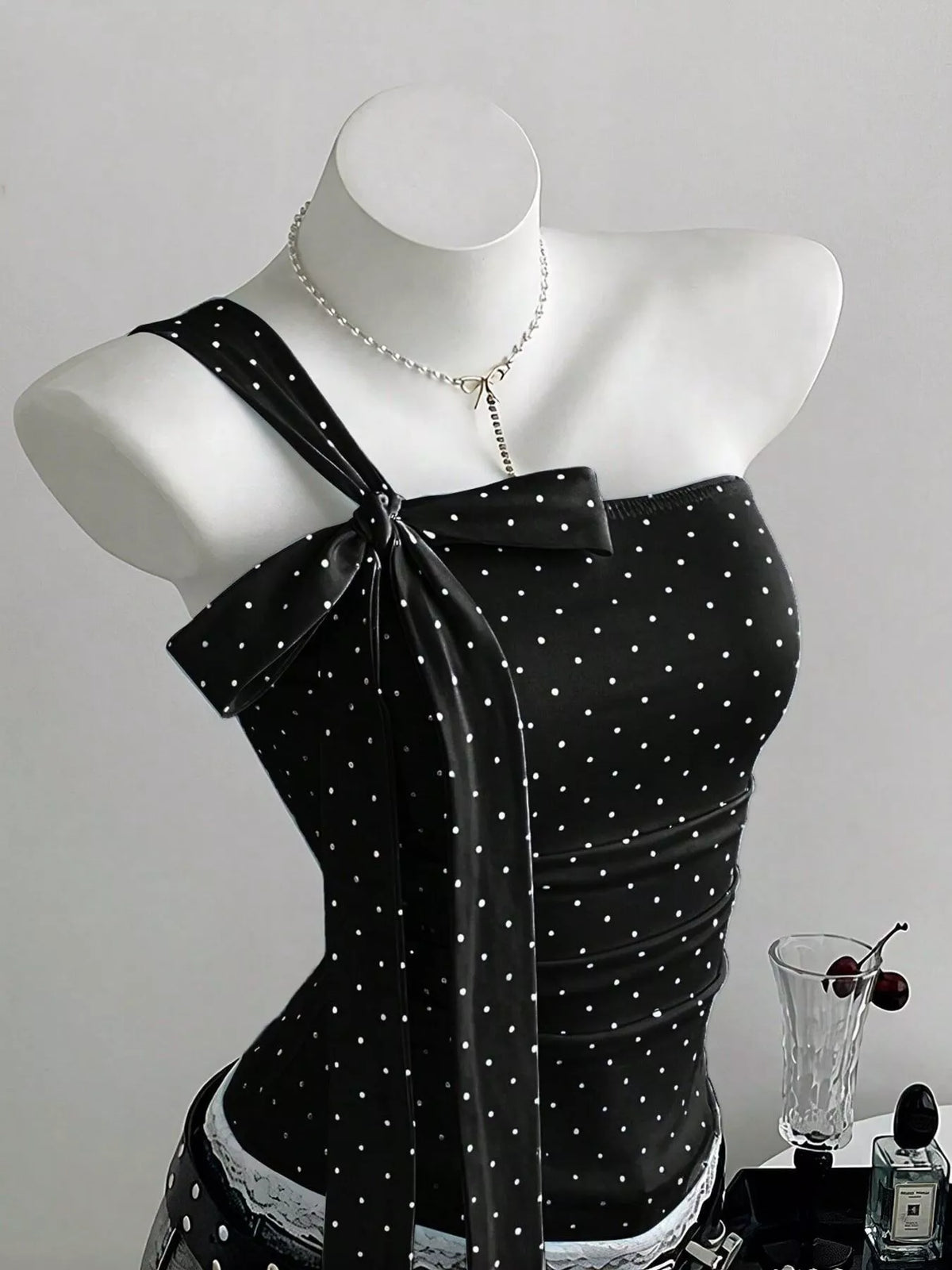 Close up of the one shoulder neckline and lace detail