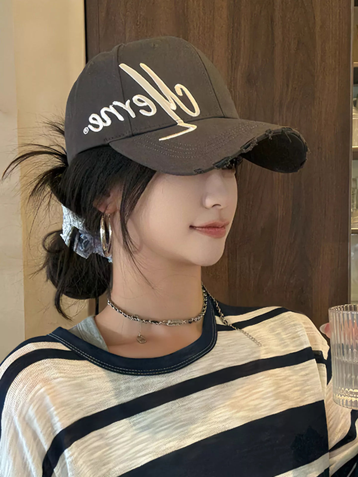 Script embroidered cotton cap shown in a dark neutral