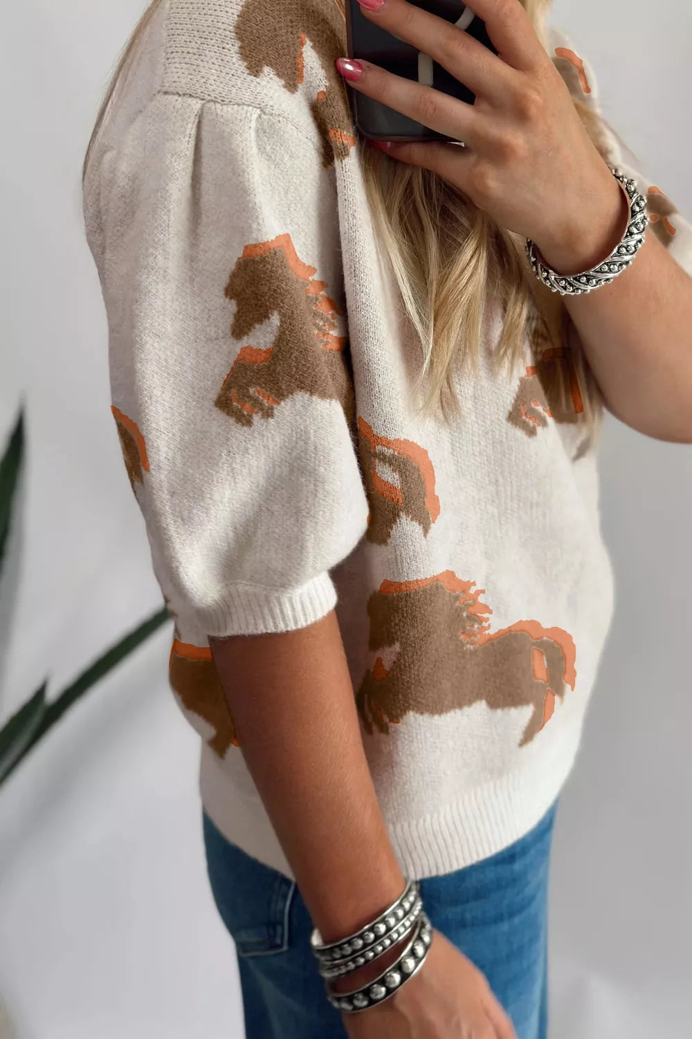 Puff sleeve detail on beige western sweater