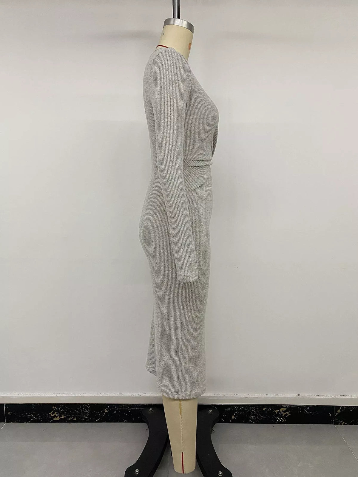 Full length styling shot of the ribbed midi dress with boots