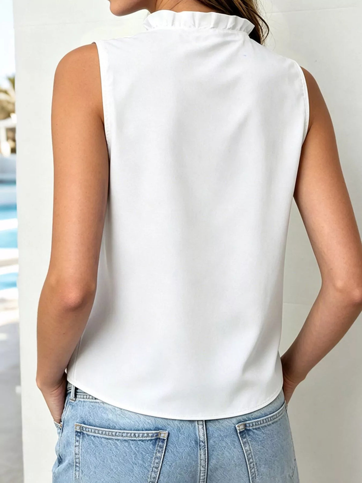 Three quarter view of the sleeveless ruffle top