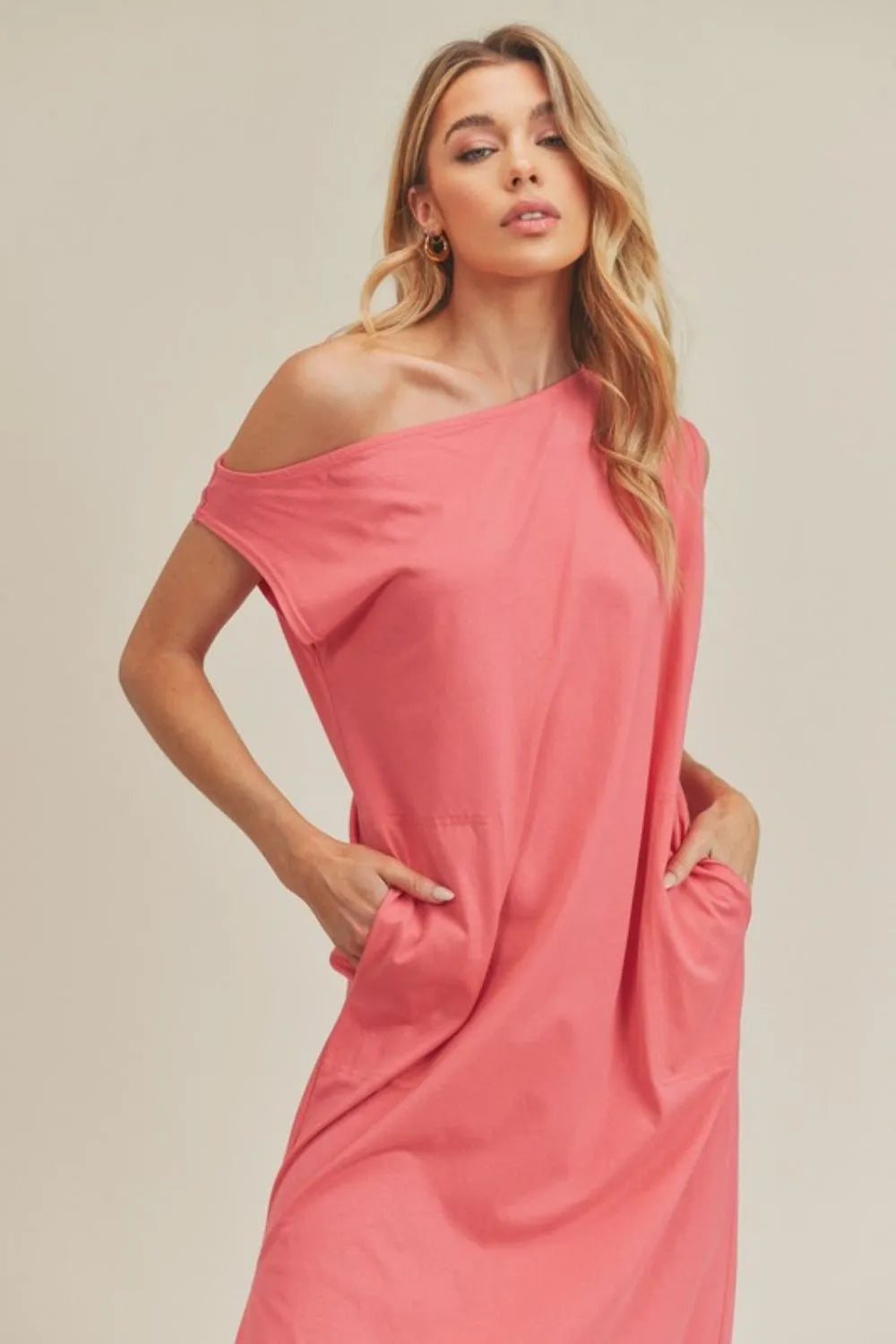 Coral sleeveless midi dress on model side view