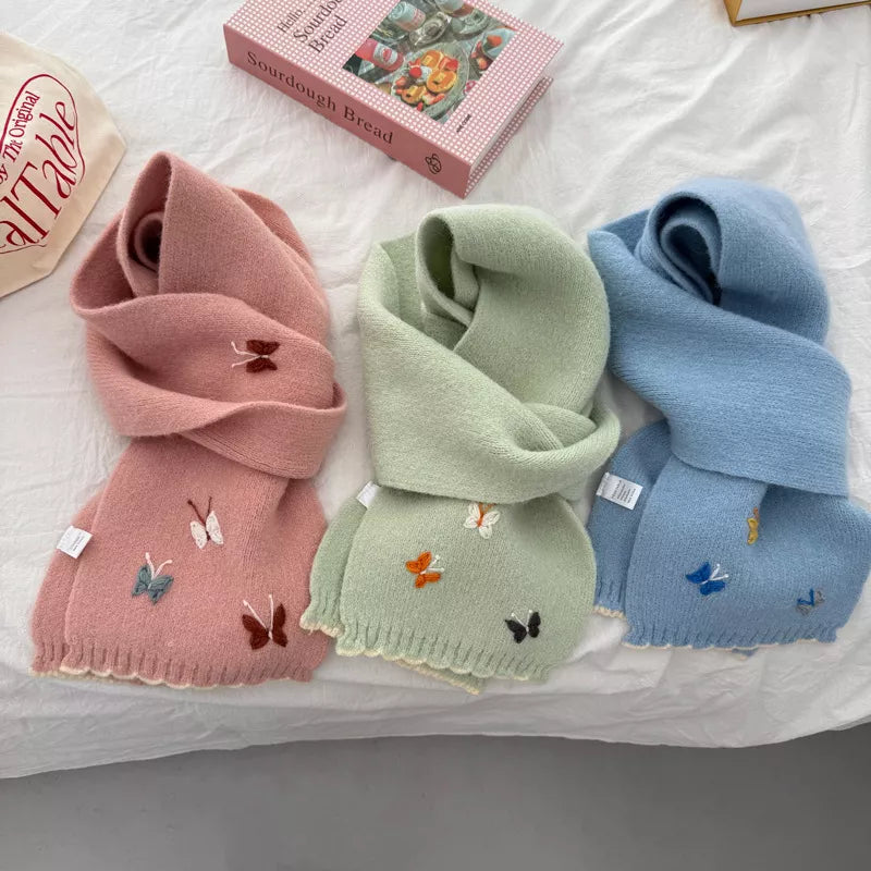 Butterfly embroidered scarf styled with a winter coat