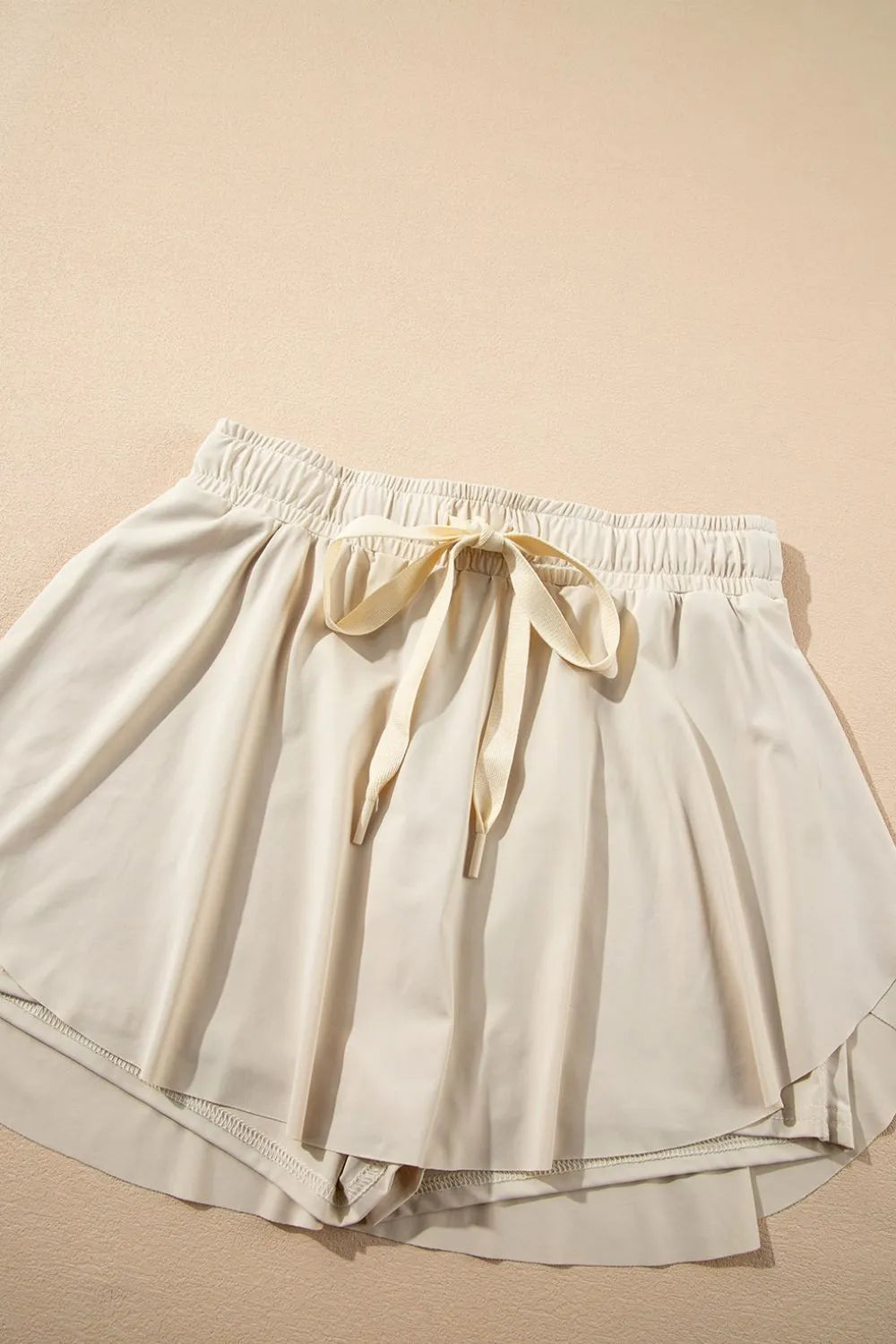 Drawstring high waist lined active skort flat lay view