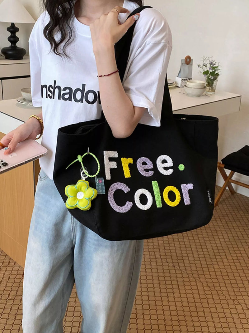 Letter print canvas shoulder bag front view