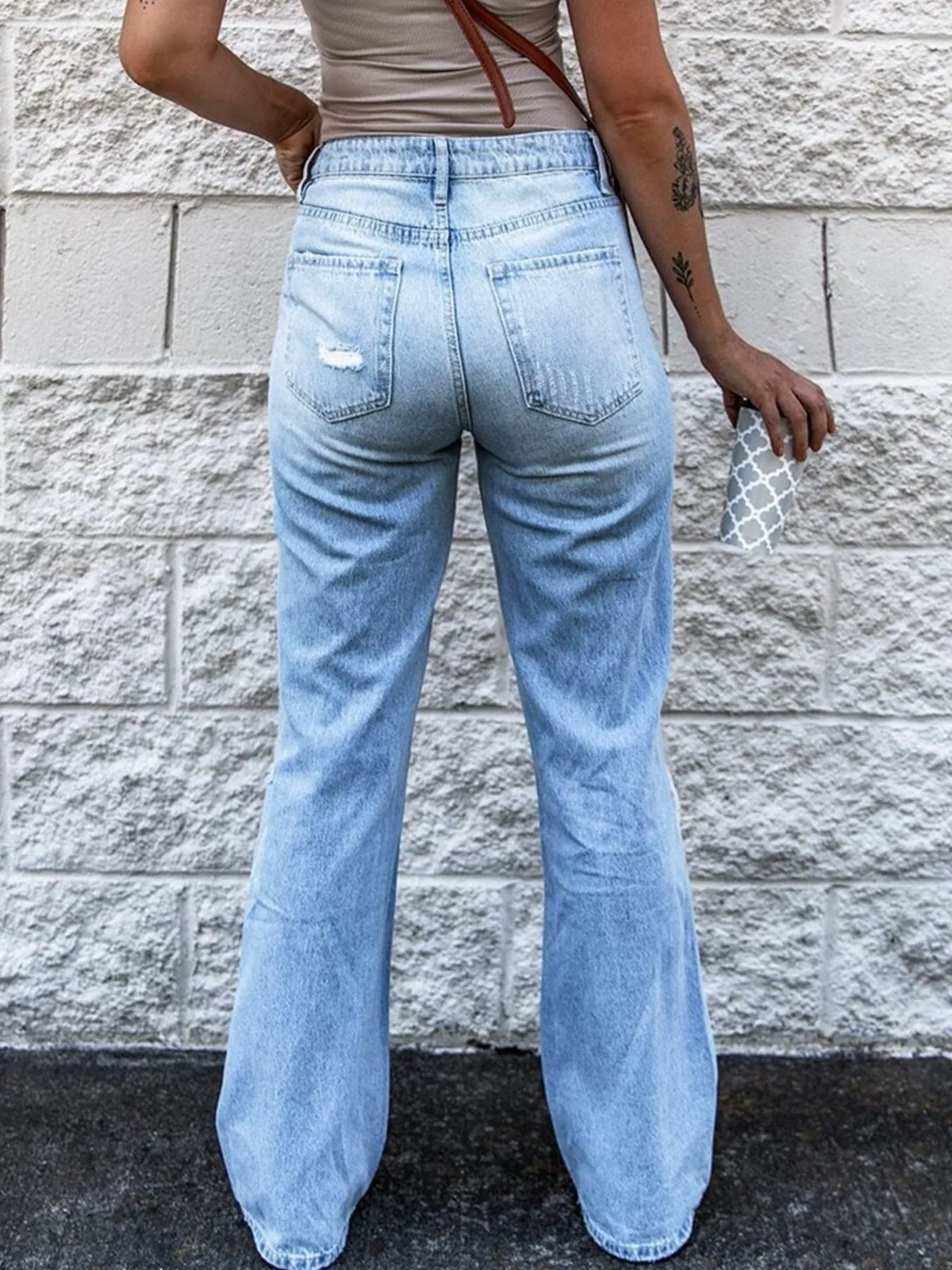 Distressing detail on high waist light blue jeans