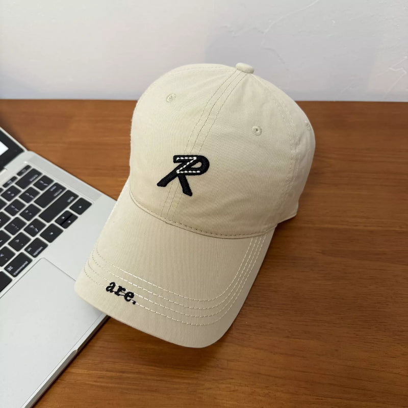 Letter embroidered baseball cap in cream white, front view