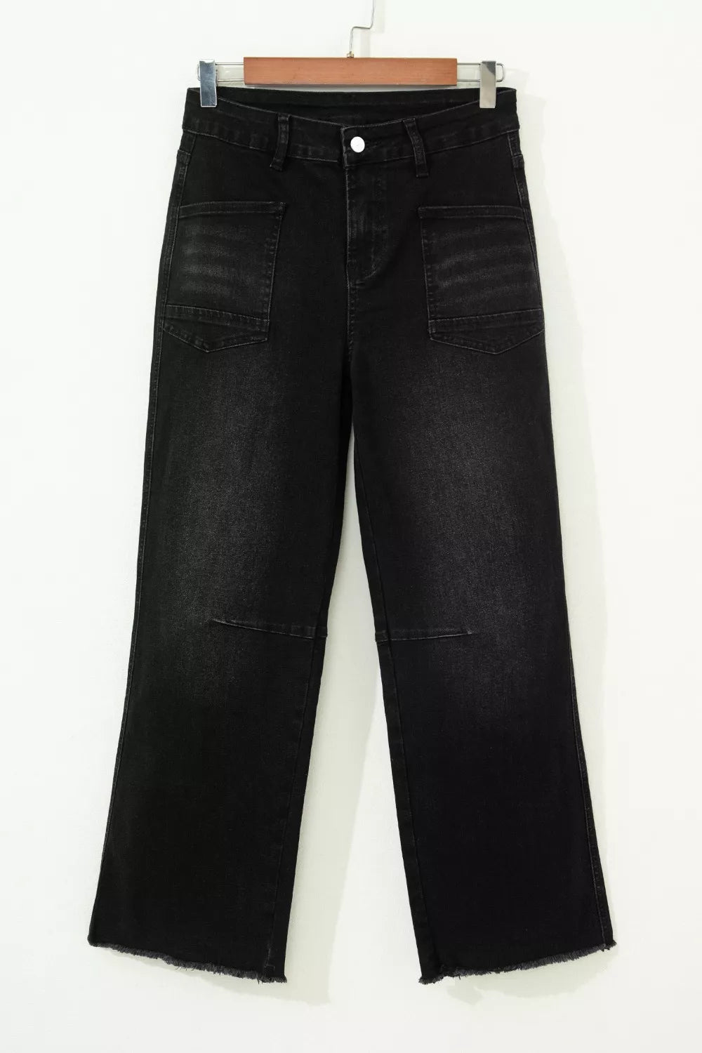 Black cropped jeans showing frayed raw hem
