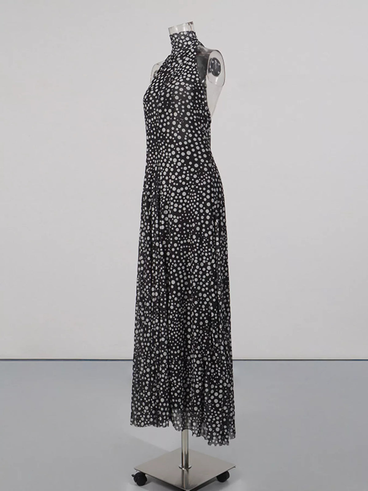 Black halter neck polka dot maxi dress, skirt movement detail