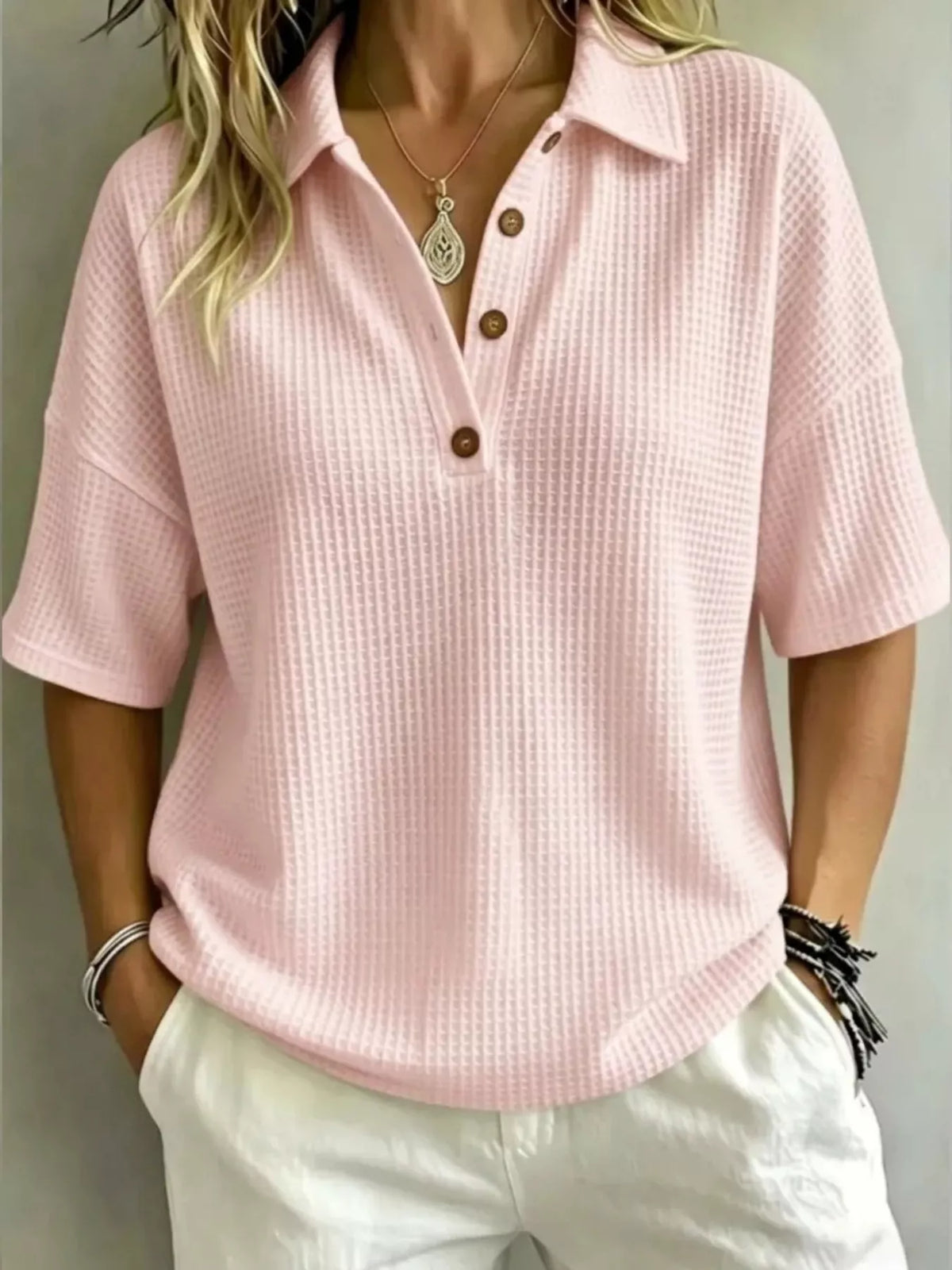 Waffle knit polo top in black shown on a model