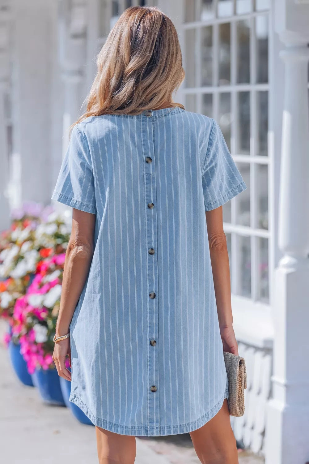 Light blue striped button back denim mini dress, back view