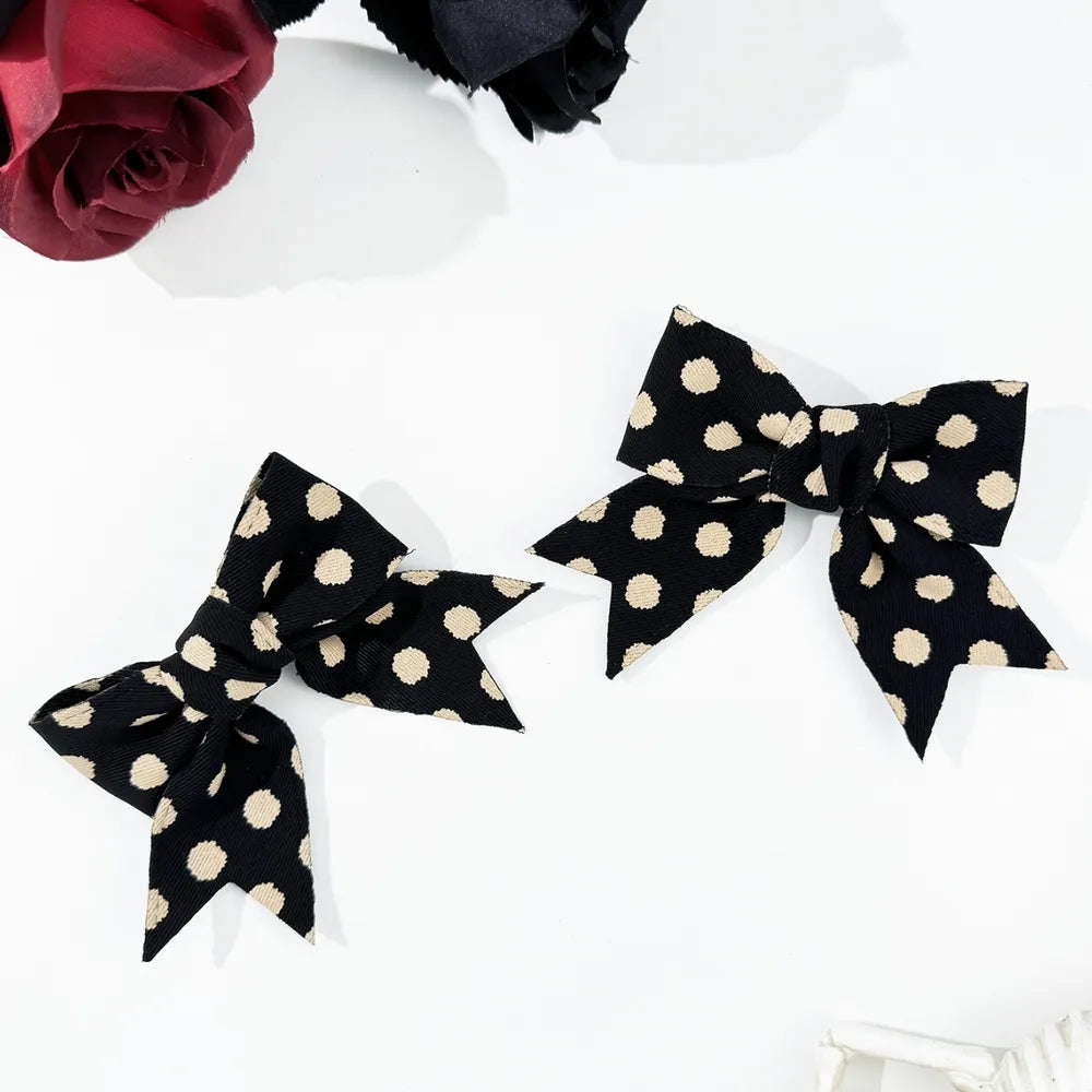 Polka dot bow hair clip pair side by side
