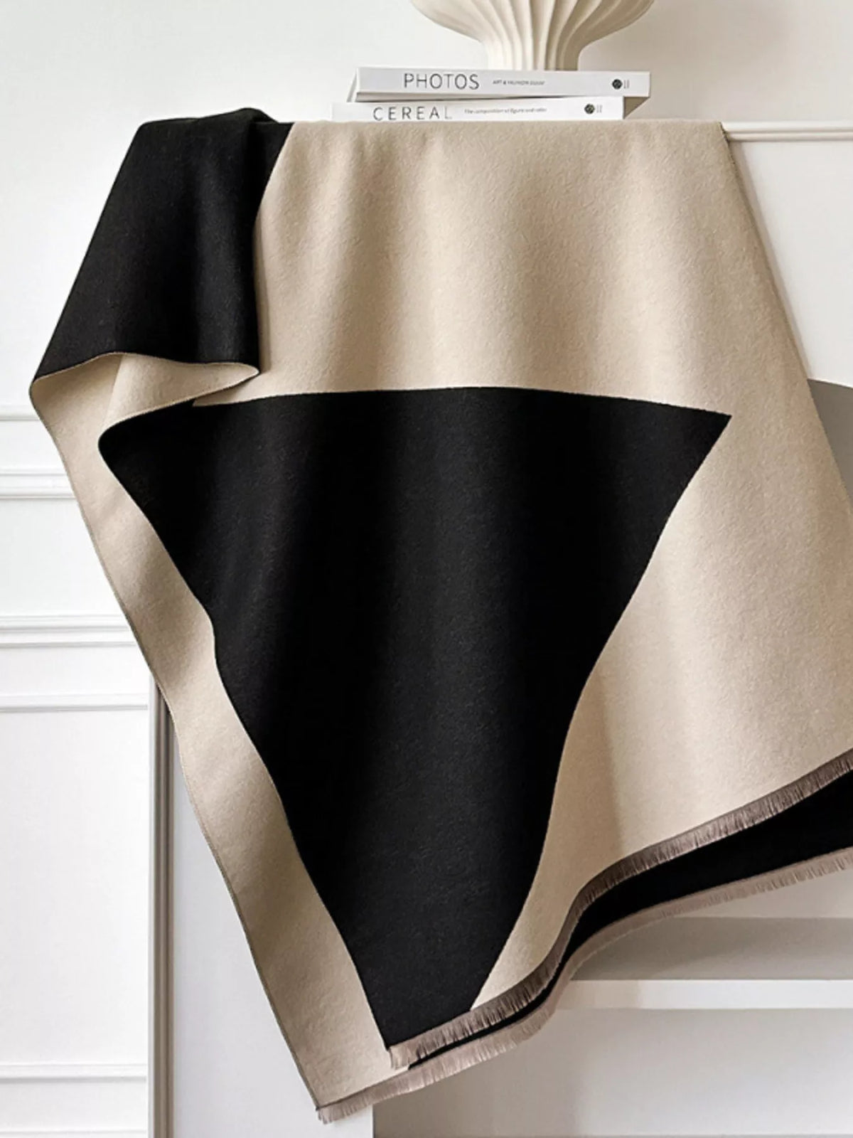Soft neutral wrap scarf styled over a jacket