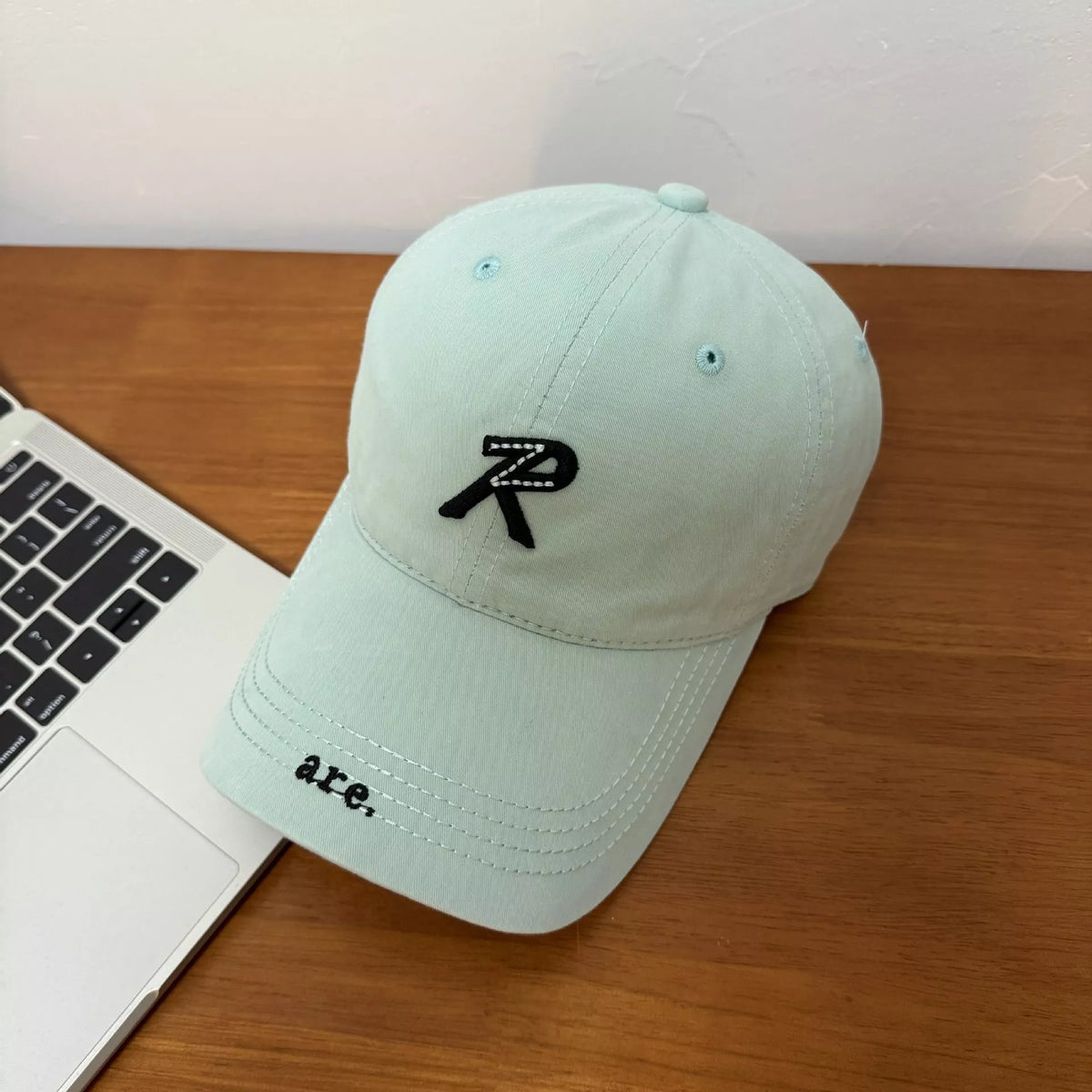Letter embroidered baseball cap in sky blue, front view