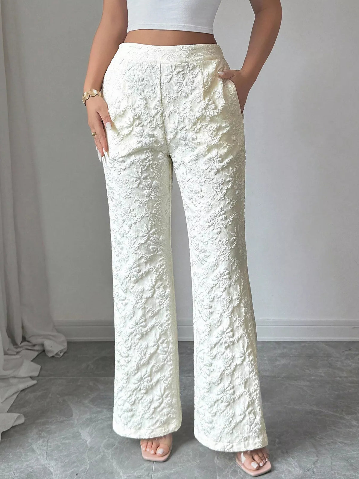 White wide leg trousers shown from the back