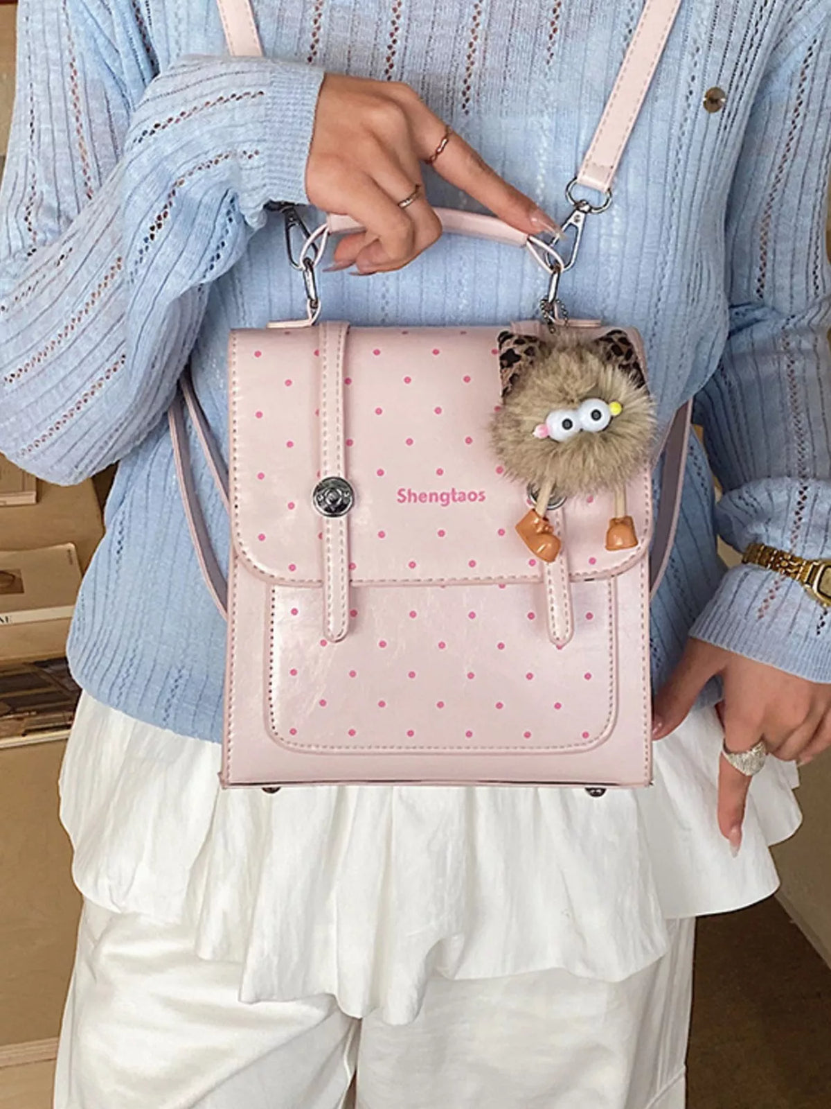 Blush pink polka dot mini backpack flat lay styling