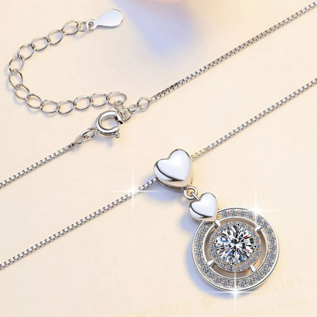 Moissanite pendant shown at an angle to catch the light