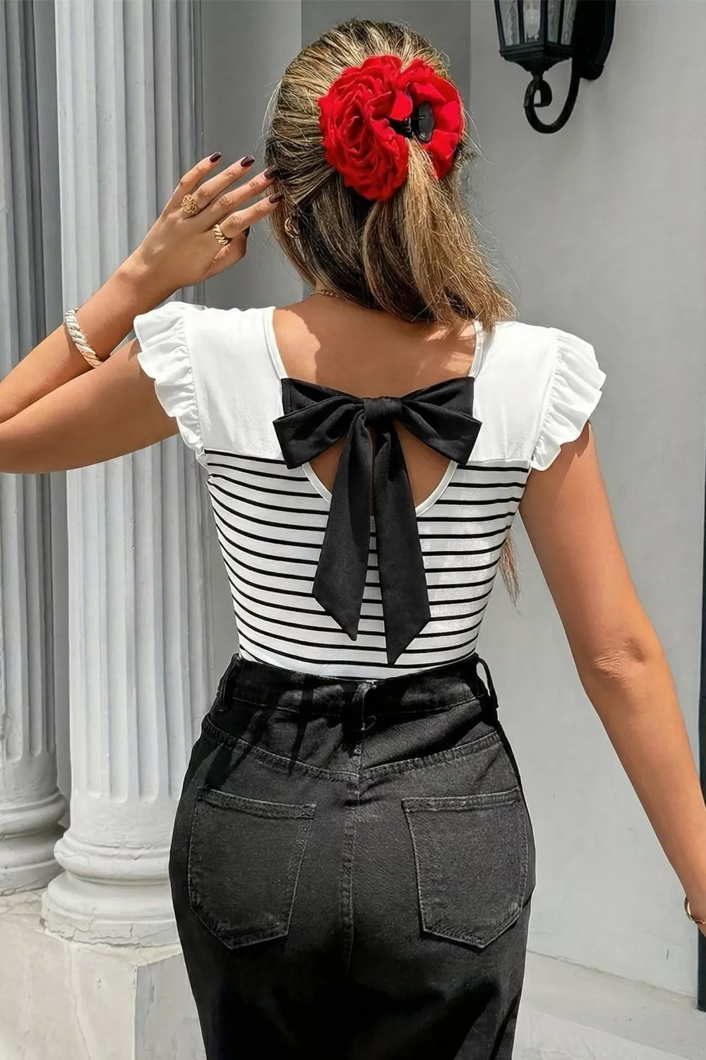 Striped tank top styled on model, side angle