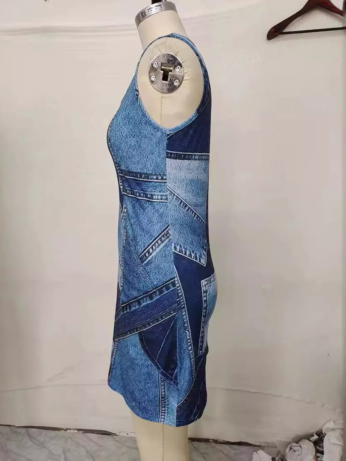 Sleeveless dress styled with a straw bag
