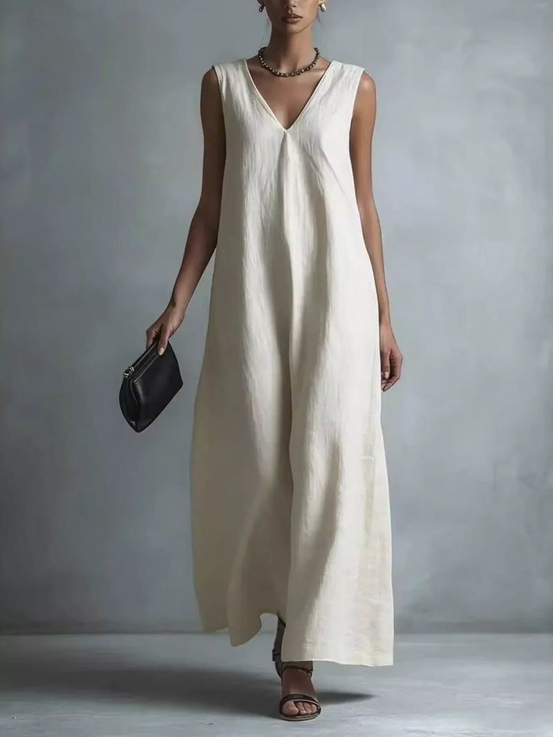 Sleeveless V neck maxi dress worn with flat sandals and a clutch