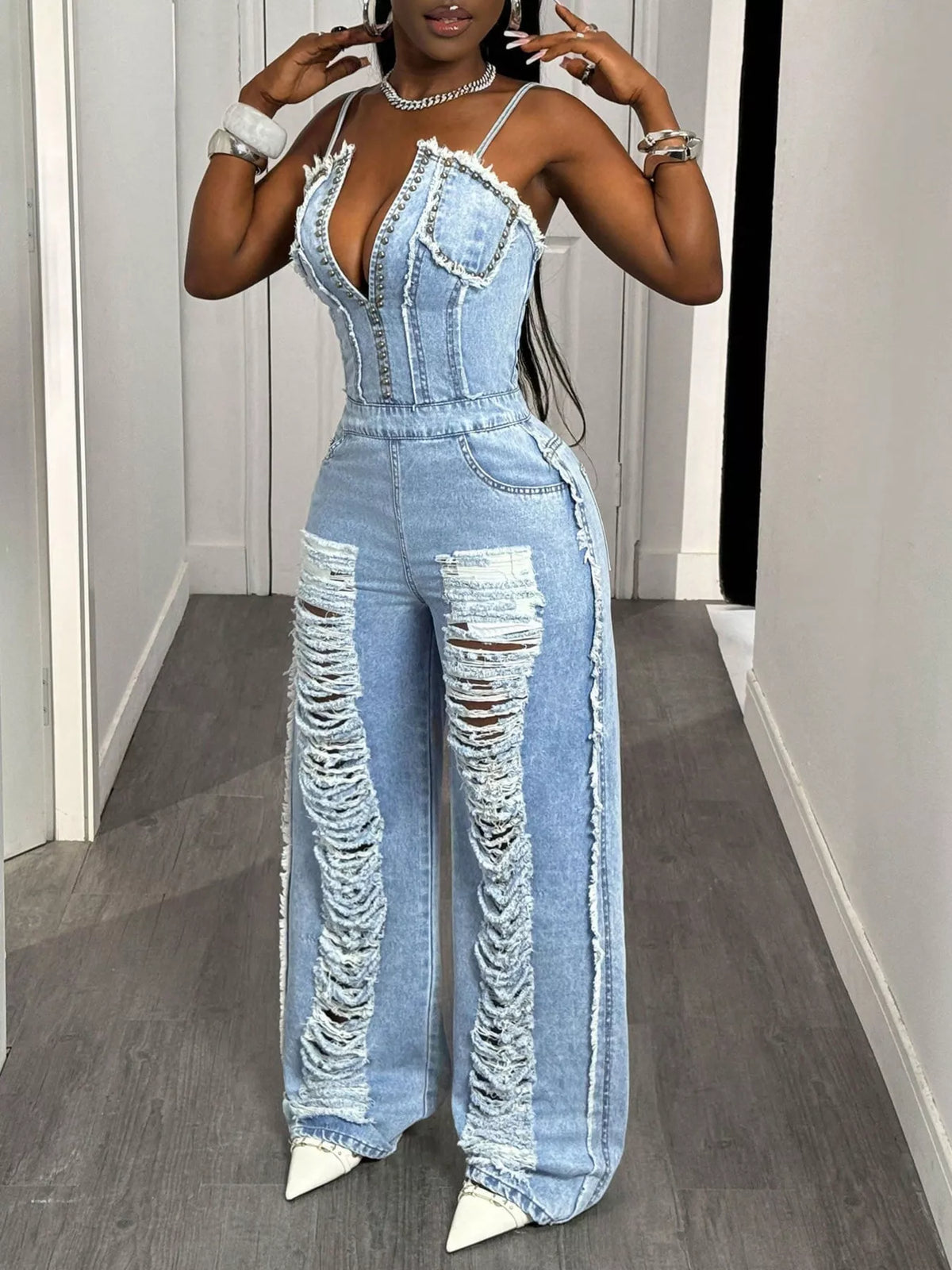 Back view of the blue distressed denim jumpsuit