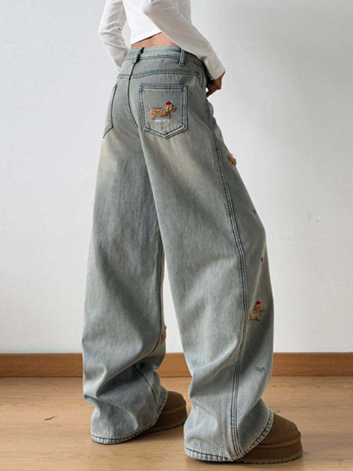 Embroidery detail on light wash denim