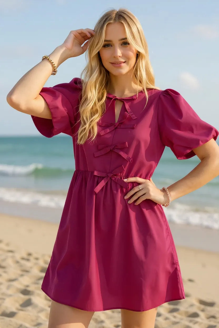 Cerise pink bow ruched puff sleeve mini dress front view