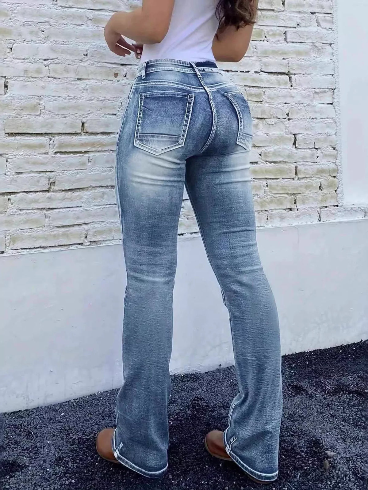 Back view of high waist bootcut jeans with pockets